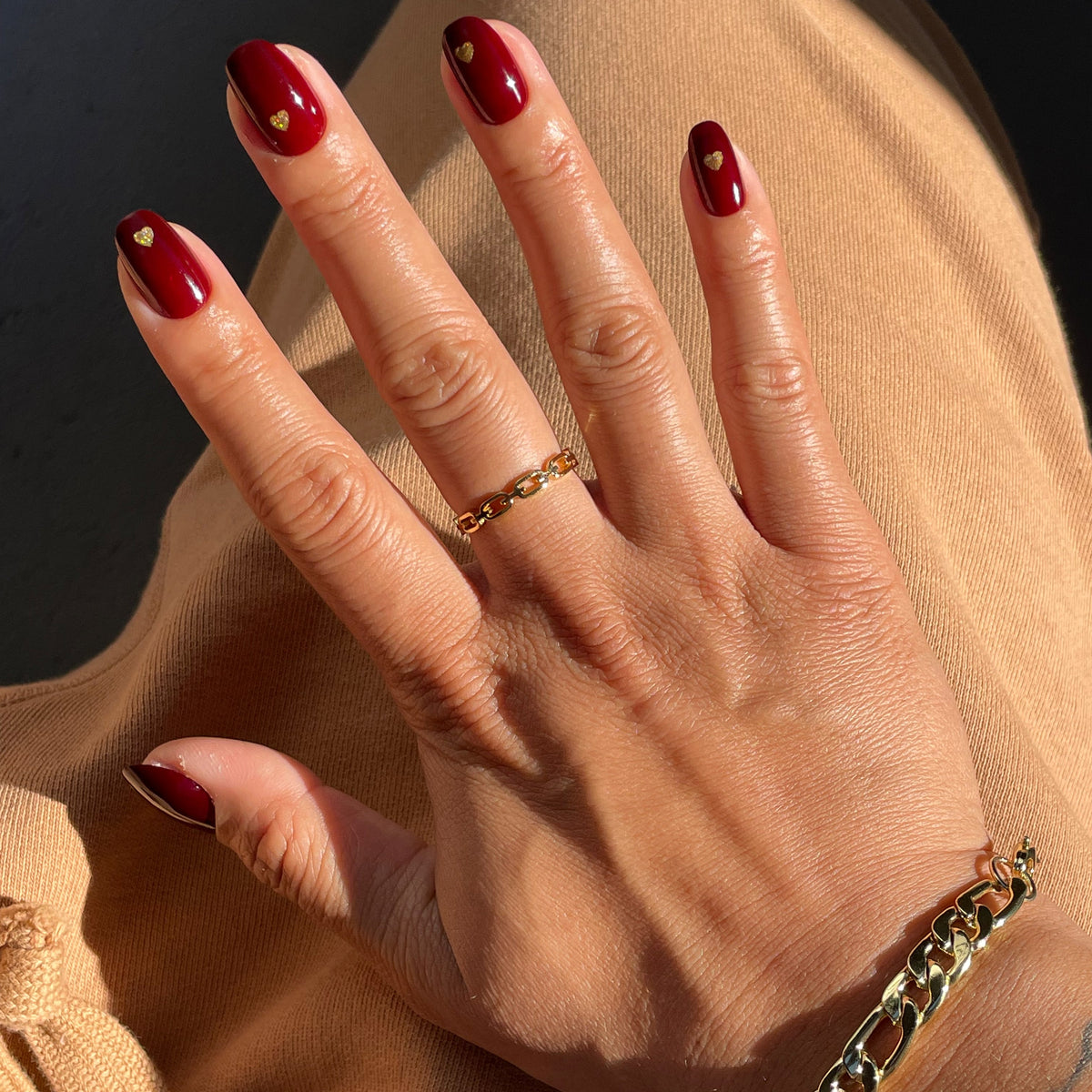 Gold Vampy Heart - Press-On | Short | Round with deep vampy red polish and small gold heart accents for at-home manicure